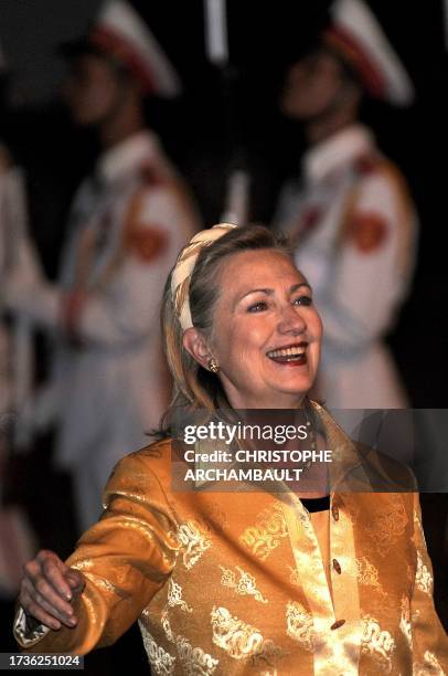 Secretary of State Hillary Clinton smiles as she walks on the tarmac upon her arrival to Vietnam to take part in the 17th ASEAN Summit and Related...