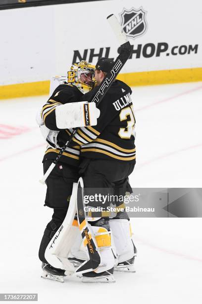 Jeremy Swayman and Linus Ullmark of the Boston Bruins hug after the win against the Nashville Predators on October 14, 2023 at the TD Garden in...
