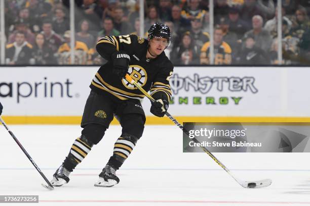 Hampus Lindholm of the Boston Bruins skates with the puck against the Nashville Predators on October 14, 2023 at the TD Garden in Boston,...