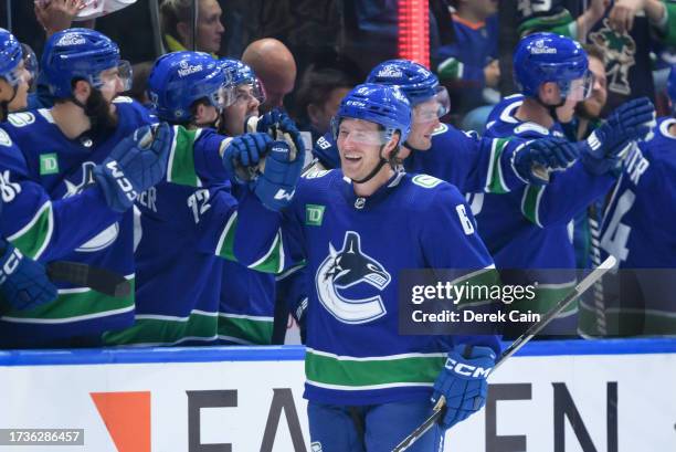 Brock Boeser of the Vancouver Canucks is congratulated at the players bench after scoring his third goal during the second period of their NHL game...