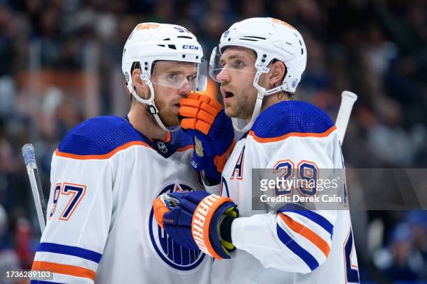 Connor McDavid and Leon Draisaitl of the Edmonton Oilers wait for a face-off during the second period of their NHL game against the Vancouver Canucks...