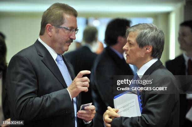 German state secretary of Agriculture Robert Kloos and EU commssioner for Agriculture and Rural Development Dacian Ciolos talk prior to an afternoon...