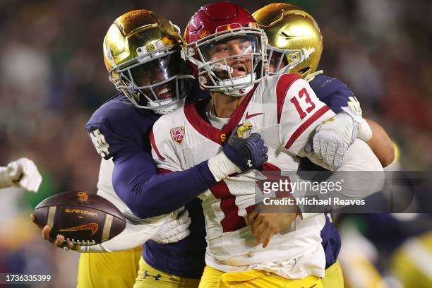 Caleb Williams of the USC Trojans is sacked by Jaylen Sneed of the Notre Dame Fighting Irish during the second half at Notre Dame Stadium on October...