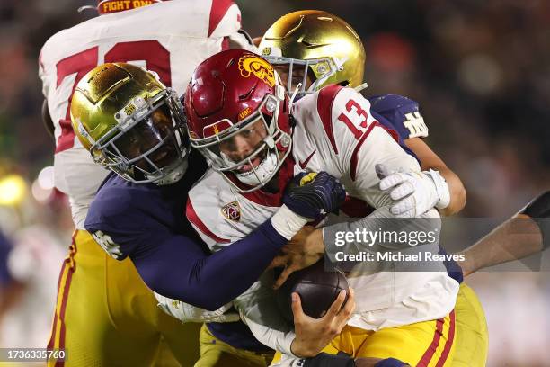 Caleb Williams of the USC Trojans is sacked by Jaylen Sneed of the Notre Dame Fighting Irish during the second half at Notre Dame Stadium on October...