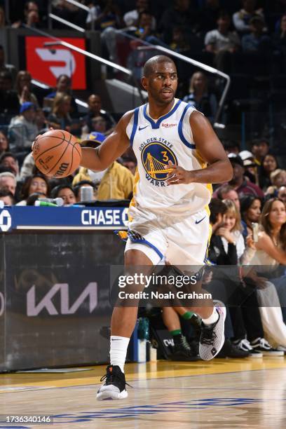 Chris Paul of the Golden State Warriors dribbles the ball during the game against the San Antonio Spurs on October 20, 2023 at Chase Center in San...