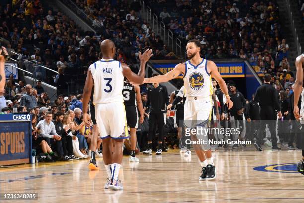 Chris Paul and Stephen Curry of the Golden State Warriors high five during the game against the San Antonio Spurs on October 20, 2023 at Chase Center...