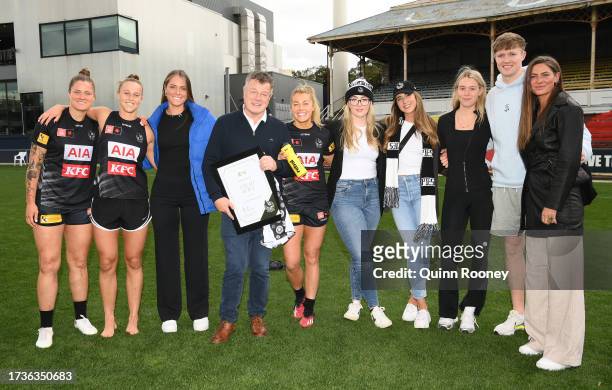 Sarah Rowe of the Magpies poses with family after being presented a plaque for reaching 50 games during the round seven AFLW match between Carlton...