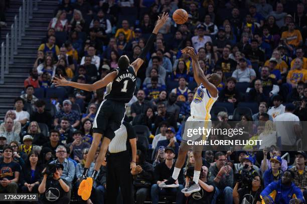 San Antonio Spurs' French forward-center Victor Wembanyama attempts to block a shot by Golden State Warriors' US guard Chris Paul during the NBA...