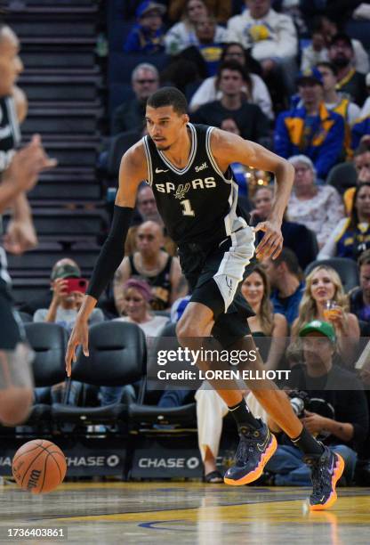 San Antonio Spurs' French forward-center Victor Wembanyama dribbles up the court during the NBA preseason game between the San Antonio Spurs and...