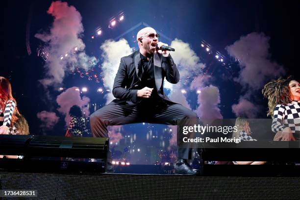 Pitbull performs onstage during The Trilogy Tour at Capital One Arena on October 14, 2023 in Washington, DC.