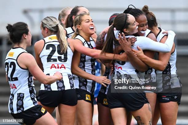 Emily Smith of the Magpies is congratulated by team mates after kicking a goal during the round seven AFLW match between Carlton Blues and...