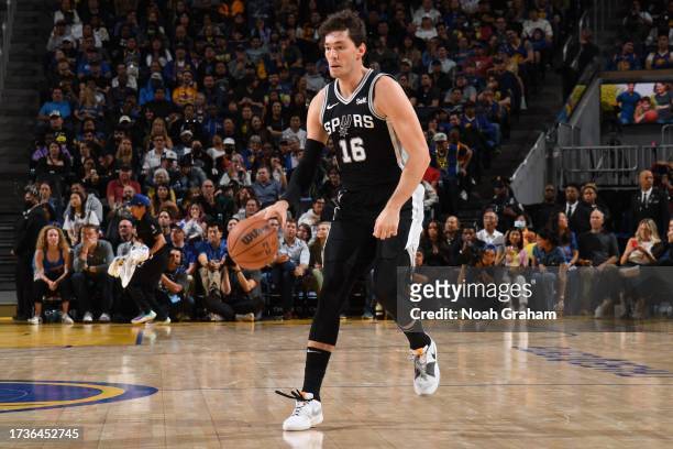 Cedi Osman of the San Antonio Spurs dribbles the ball during the game against the Golden State Warriors on October 20, 2023 at Chase Center in San...