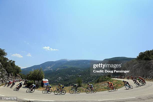 The peloton winds through the hills with the Mount Ventoux in the background during stage sixteen of the 2013 Tour de France, a 168KM road stage from...