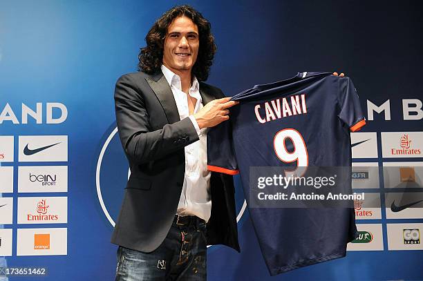 Paris Saint-Germain's new forward, Edinson Cavani, poses with his jersey during a press conference on July 16, 2013 in Paris, France. Cavani's...