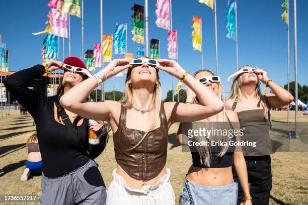 Festival goers watch the solar eclipse during 2023 Austin City Limits Music Festival at Zilker Park on October 14, 2023 in Austin, Texas.
