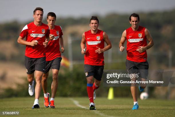 David Villa of Atletico de Madrid runs with teammates during his first training session with the club at the Los Angeles de San Rafael training...