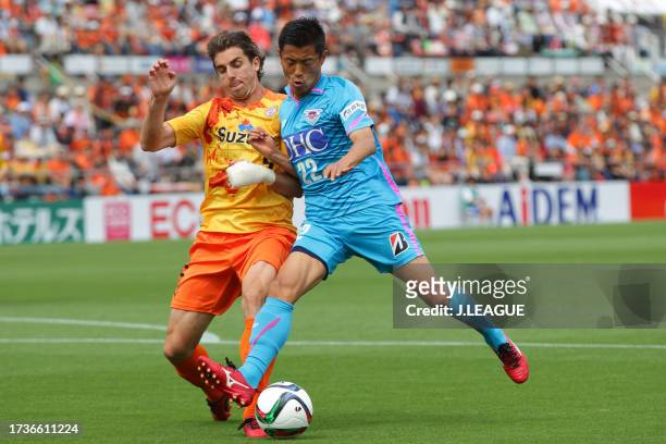 Kei Ikeda of Sagan Tosu and Dejan Jakovic of Shimizu S-Pulse compete for the ball during the J.League J1 first stage match between Shimizu S-Pulse...