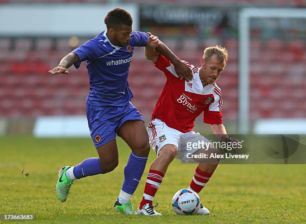 Brett Ormerod of Wrexham AFC holds off a challenge from Dave Davis of Wolverhampton Wanderers during the Pre Season Friendly match between Wrexham...