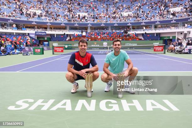 Marcel Granollers of Spain and Horacio Zeballos of Argentina pose with their trophy during the Award Ceremony after the men's doubles final match...