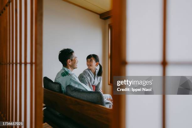 father and daughter in yukata (casual kimono) in traditional japanese room - porta di carta giapponese foto e immagini stock