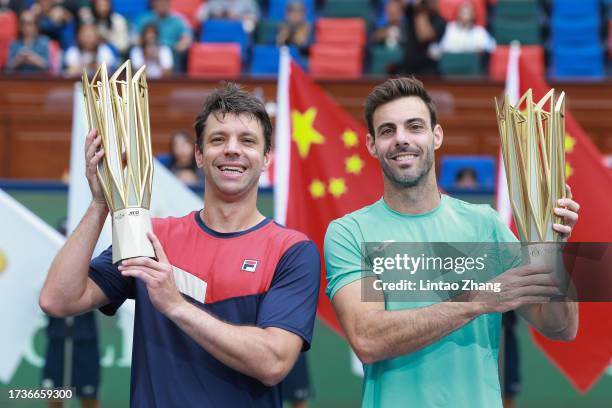 Marcel Granollers of Spain and Horacio Zeballos of Argentina pose with their trophy during the Award Ceremony after the men's doubles final match...