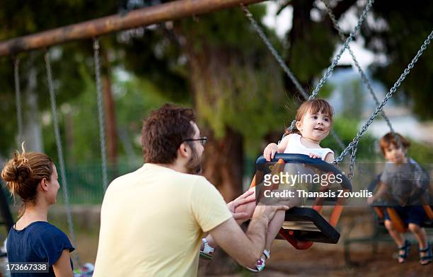 father with his daughter in a playground - mother and son at playground stock-fotos und bilder