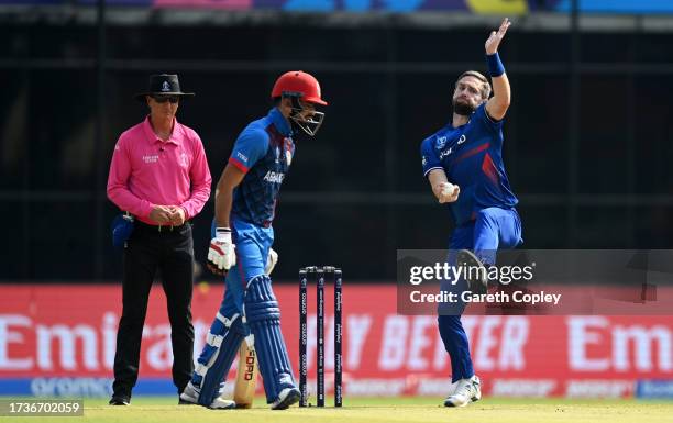 Chris Woakes of England in bowling action during the ICC Men's Cricket World Cup India 2023 between England and Afghanistan at Arun Jaitley Stadium...