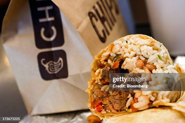 Steak burrito is arranged for a photograph with a drink and bags of chips at a Chipotle Mexican Grill Inc. Restaurant in Hollywood, California, U.S.,...