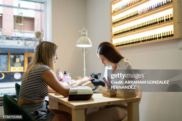 a nail technician working out of a salon - finger nails stock pictures, royalty-free photos & images