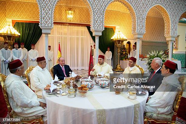 King Mohammed VI of Morocco and his brother Prince Moulay Rachid receives King Juan Carlos of Spain at the Royal Palace for a official dinner during...