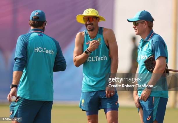 Mitchell Starc of Australia speaks with bowling coach Daniel Vettori and coach Andrew McDonald during an Australian training session at the ICC Men's...