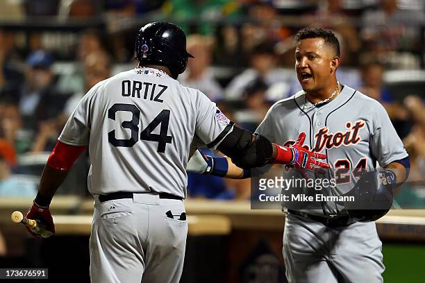 American League All-Star David Ortiz of the Boston Red Sox greets American League All-Star Miguel Cabrera of the Detroit Tigers after Cabrera scored...