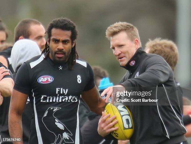 Harry O'Brien of the Magpies and Nathan Buckley the coach of the Magpies talk during a Collingwood Magpies AFL training session at Olympic Park on...