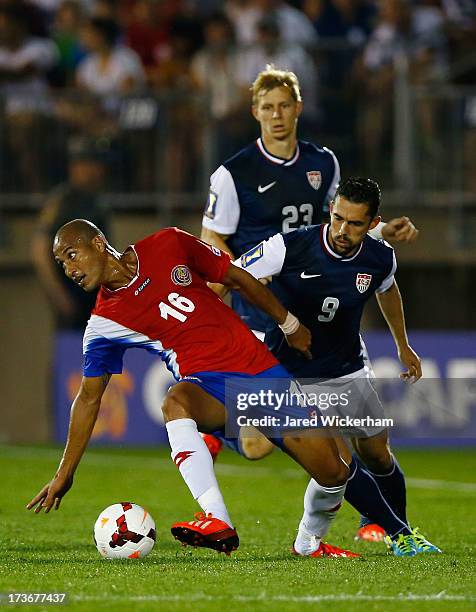 Carlos Johnson of Costa Rica carries the ball in front of Herculez Gomez of the United States during the CONCACAF Gold Cup match at Rentschler Field...