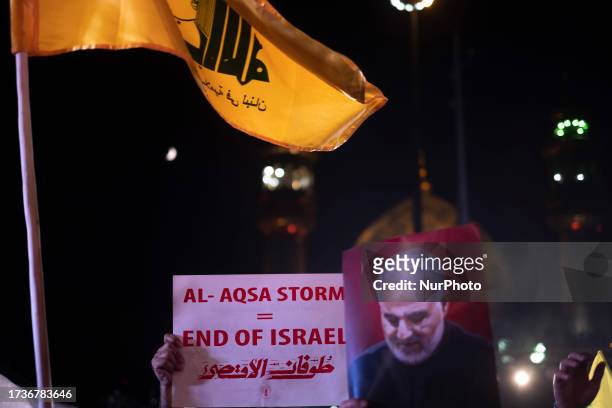 Iranian protesters hold-up an anti-Israeli placard, a portrait of former commander of Islamic Revolutionary Guard Corps' Quds Force, General Qasem...