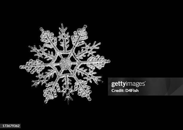 icy snowflake on a black background - black and white photo to colour stock pictures, royalty-free photos & images