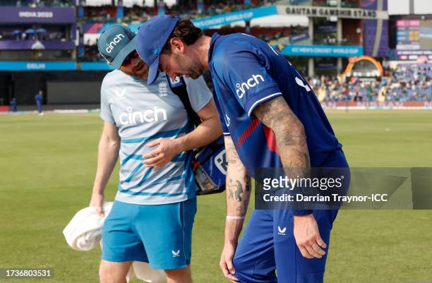 Reece Topley of England receives medical attention during the ICC Men's Cricket World Cup India 2023 between England and Afghanistan at Arun Jaitley...