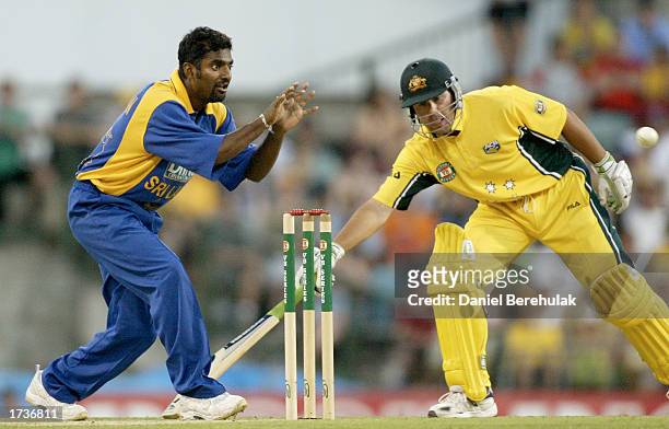 Muttiah Muralitheran of Sri Lanka fields a ball as Ricky Ponting of Australia scrambles back to his crease during the VB series One Day International...
