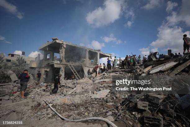 Residents inspect the damage left by the Israeli bombing of the Abu Sahaq family's house in Bani Suhaila, east of Khan Yunis, south of the Gaza...