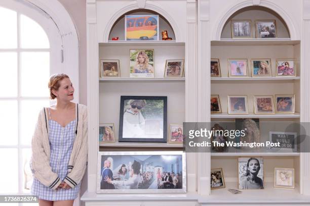 Molly Swindall stands with some of her autographed album covers in her collection of Taylor Swift memorabilia that she keeps at her childhood home in...