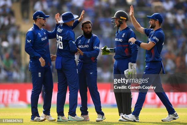 Adil Rashid of England celebrates the wicket of Ibrahim Zadran of Afghanistan during the ICC Men's Cricket World Cup India 2023 between England and...