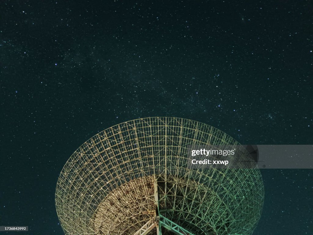 Huge white satellite dish under the starry sky