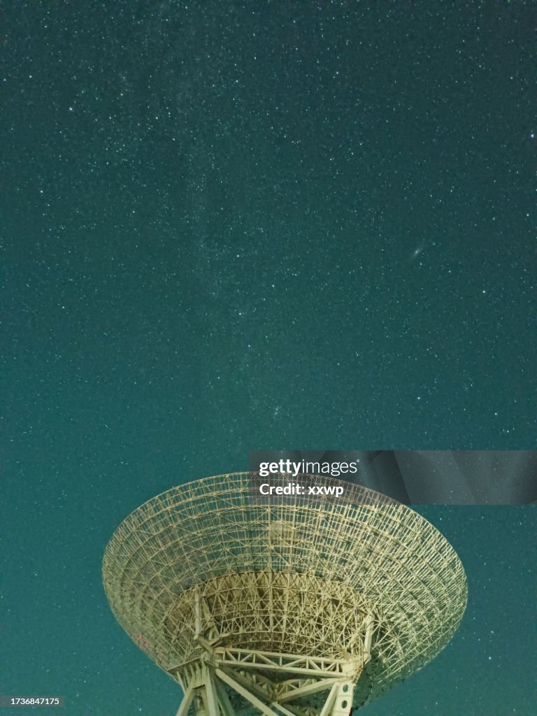 Huge white satellite dish under the starry sky