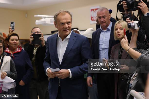 Donald Tusk, co-leader of Civic Coalition, a center-left pro-European political coalition, arrives to vote in Polish parliamentary elections on...