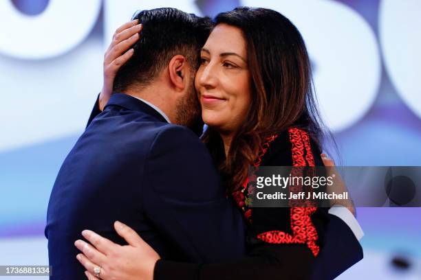 Scottish First Minister Humza Yousaf embraces his wife Councillor Nadia El-Nakla after she spoke during an emergency motion on Irael – Palestine...