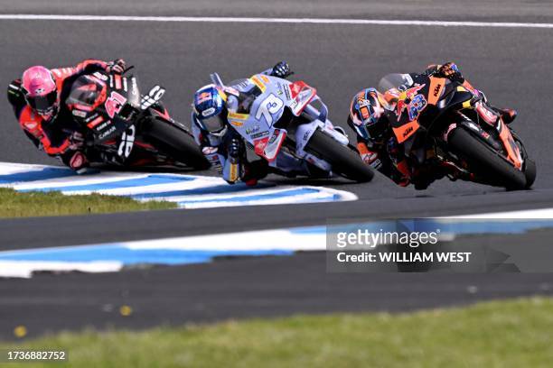 Red Bull KTM Factory Racing's Australian rider Jack Miller escorts Gresini Racing MotoGP's Spanish rider Alex Marquez and Aprilia Racing's Spanish...
