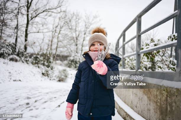 ghiaccioli nella mano di un bambino. - icicles foto e immagini stock