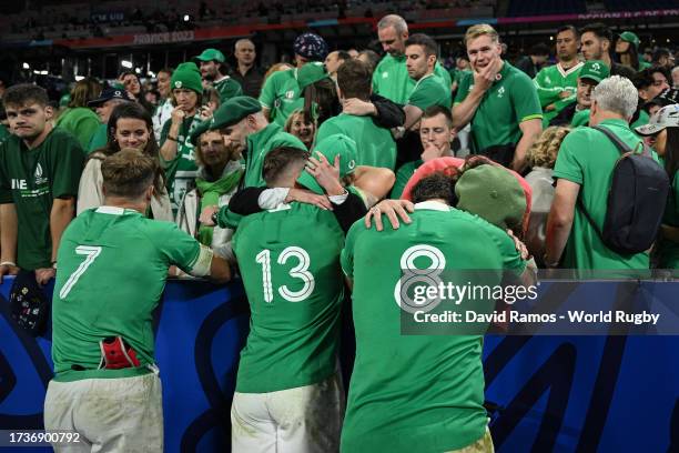 Josh Van der Flier, Garry Ringrose and Caelan Doris of Ireland are consoled by members of the crowd at full-time after their team's loss in the Rugby...