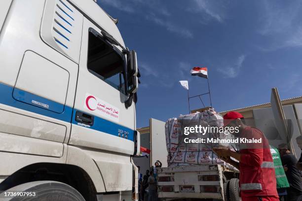 Aid convoy trucks are checked as they prepare to cross the Rafah border from the Egyptian side on October 21, 2023 in North Sinai, Egypt. The aid...