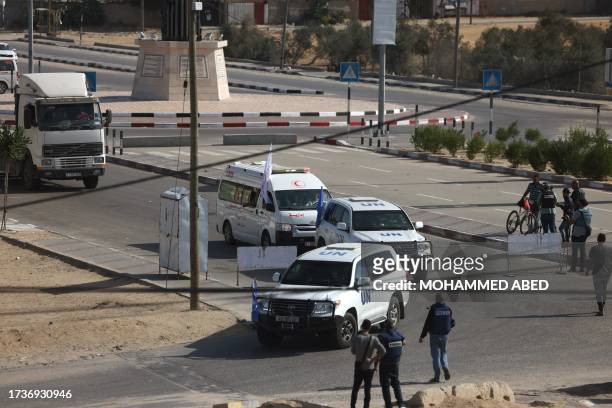 United Nations vehicles and empty lorries wait on the Palestinian side of the Gaza border at Rafah to collect humanitarian aid to be delivered from...